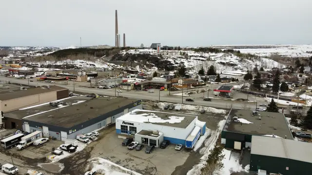 Aerial photo of the existing Webbwood building among industrial lots, with the Sudbury Superstack on the horizon