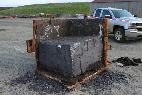 A large cast slag block sitting in its opened steel form