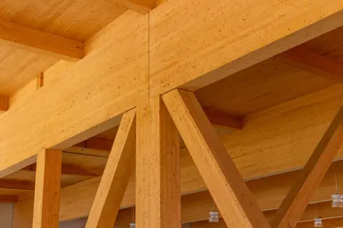 Close view of a glulam column meeting its beams and braces