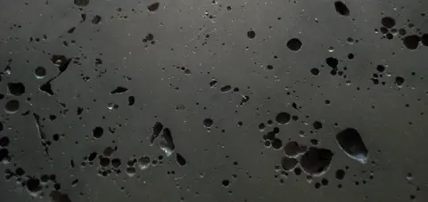 Close-up of polished slag with dark pores