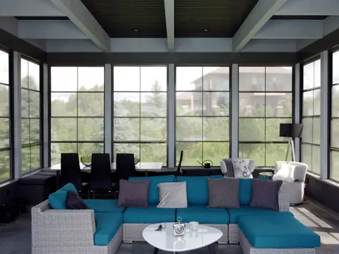 Lounge interior with full-height windows on three sides