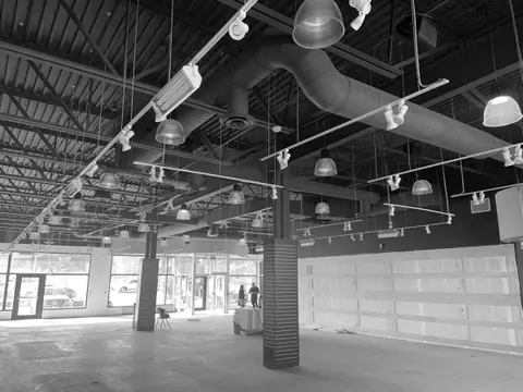 Black and white photo of the empty unit before the fit-up