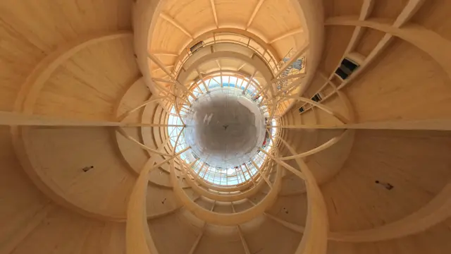 Flattened 360-degree photo looking up through the glulam frame of a DAO mass timber building under construction
